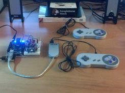 A BeagleSNES v0.4 system running on a BeagleBone Black board with two USB gamepads via an external USB hub