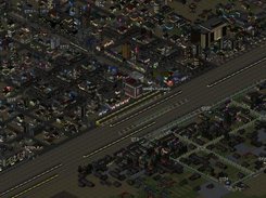 A nighttime view of a suburb split by a large rail line