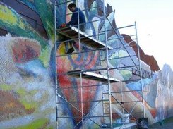 Cleaning a section of the Barrio Anita tile mural in Tucson.